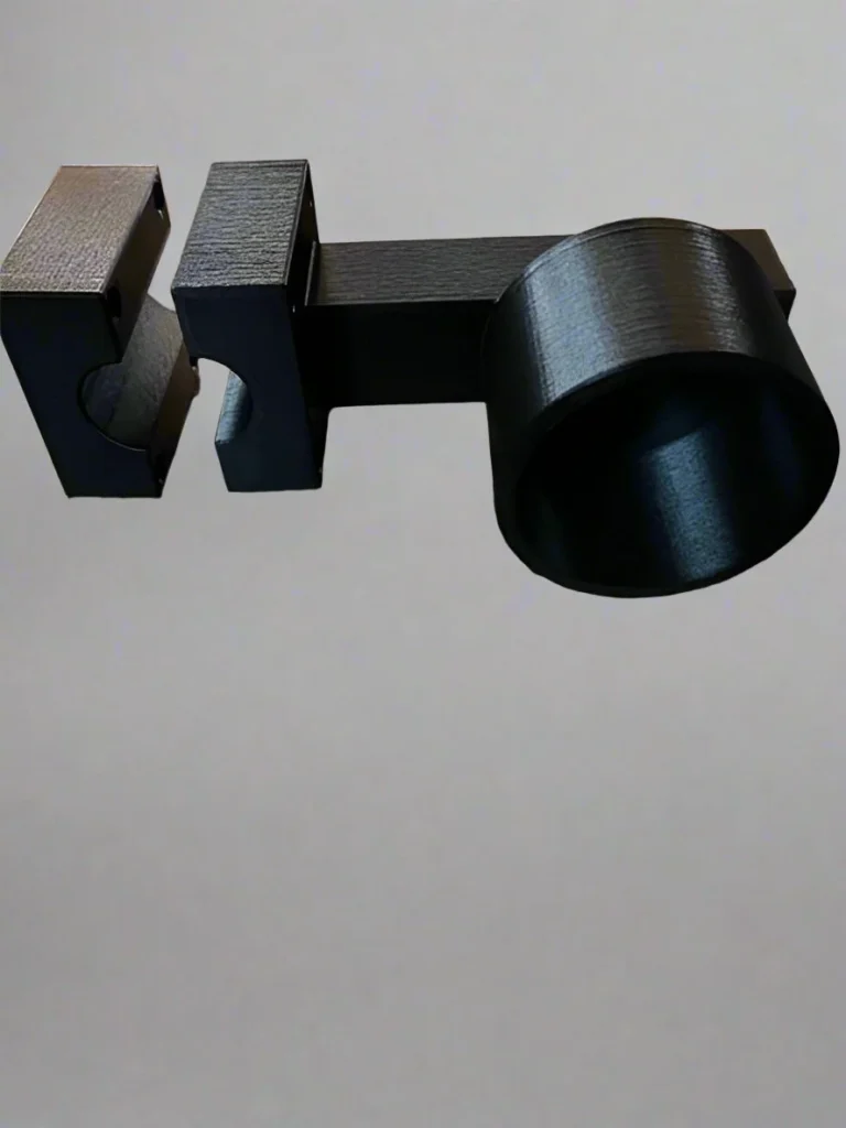 Black printed bracket with a rectangular slot at one end and a circular opening at the other.